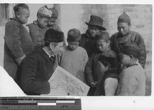 Fr. Fraser teaching people on the street at Chekiang, China, 1913