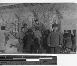 Rev. George A. Flick, MM, playing a game with orphan boys at Chaoyangzhen, Manzhoukuo, China, 1939