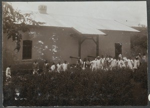 Gathering of people in front of house, Tanzania