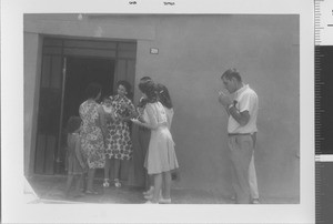 Sarah Miller and group in front of house