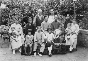 Ellen Nielsen and Astrid Poulsen in Ellen Nielsen's garden with Bao Chen, his family and Jung L