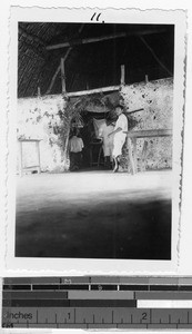 Armed man stands guard outside a marriage ceremony, Quintana Roo, Mexico, ca. 1946