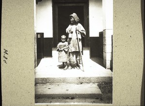 A beggar with her son (crippled hand)