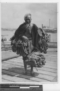 A man carrying rope in China, 1937