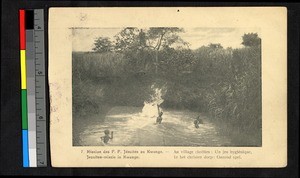 Boys splashing in a pool outdoors, Congo, ca.1920-1940