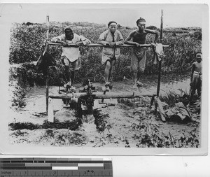 Men working the water pump at Shanghai, China, 1942