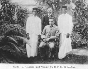 Missionary L.P.Larsen (seated) and missionary Knud Heiberg (standing) with friends at YMCA in M