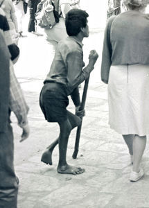 Nepal, 1986. A physically disabled boy is moving around by using a stick