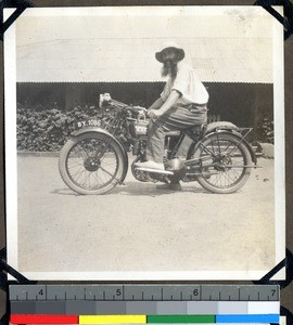 Father Sirlinger on a motorbike, Shendam, Nigeria, 1923