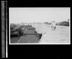 Two Western women standing on the city wall. Chengdu, Sichuan, China, ca.1935