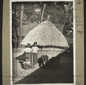 Mulki. Rice stack. In front two girls from the boarding school