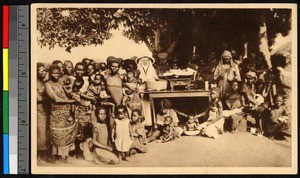 Missionary sisters weighing infants among a crowd of young mothers, Congo, ca.1920-1940