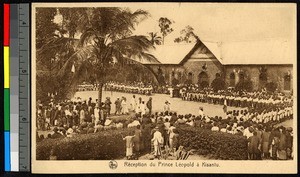 People gathered before a brick school building to welcome Prince Leopold of Belgium, Congo, ca.1920-1940