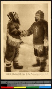 Two missionary fathers shaking hands in indigenous fur clothing, Canada, ca.1920-1940