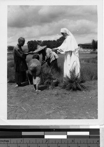 Maryknoll Sister talking a farmer in a field, Kaying, China, ca.1949