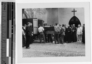 Placing Fr. Damien's remains in improvised hearse, Hawaii, 1936