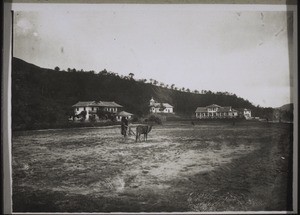 "The mission station Tschhonglok (Wufa). Girls' boarding school, chapel, and the mission house. Behind: school and houses for assistants. The girls' boarding school was formerly a branch hospital. But the school was brought here from Tschongtshun in 1920."