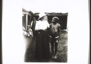 Cameroon, Grassfields. Mrs Rein-Wuhrmann with a pygmy woman who is holding dance-rattles