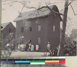 Ole Jensenius standing to the right of the building, Bara region, Madagascar, ca.1900