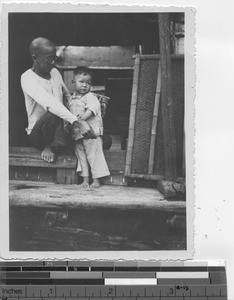 Man and child born on a sampan at Wuzhou, China, 1947