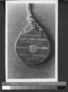 A medal given to Emily S. Hartwell by the Republic of China, Fuzhou, Fujian, China, 1918 Dec. 19