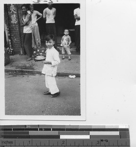 A boy and his caged bird at Hong Kong, China, 1940