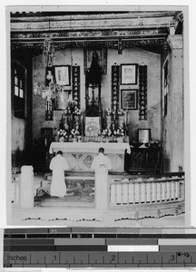 Two priests praying in a church in the Hakka mission, China, 1926