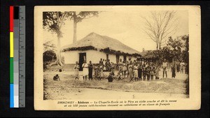 Young catechumens standing outside of a thatch-roofed school building, Benin, ca.1920-1940