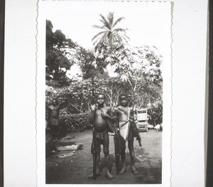 Two young visitors to the mission festival in Babesi, carrying gun and umbrella