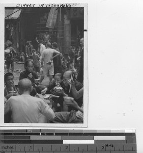 Supper time for people outside the shops at Hong Kong, China, 1943