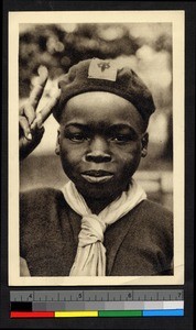 Boy wearing scarf and cap salutes, Congo, ca.1920-1940