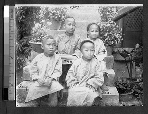 Four young boys seated on a staircase, Ing Tai, Fujian, China, ca. 1910