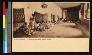People spinning wool near hanging rugs, Morocco, ca.1920-1940