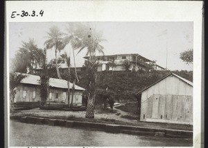 Mission Station buildings in Bonaku. Carpenter's shop, oil palms, sheds