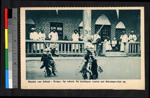 Masked dancers performing before gathered missionary fathers, Congo, ca.1920-1940