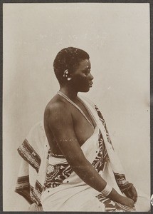 African woman sitting on a stool, Tanzania