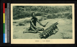 Man playing a musical instrument, Zambia, Africa, ca.1920-1940