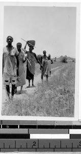 Line of five people on the side of a dirt road, Africa, 1947