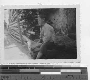 A young boy working at joss stick alley at Luoding, China, 1937