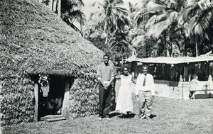 Reverend Billy and his wife with chief Henri Boula, in front of a hut