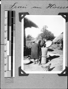 Woman with a millet masher, Msangano, Tanzania, 1937