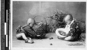 Two boys looking in baskets, Japan, ca. 1920-1940