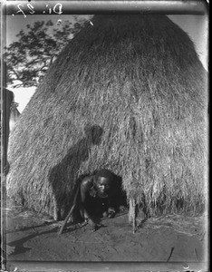 African man coming out of a hut