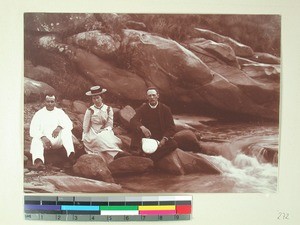 Three people resting on some stones, Madagascar