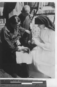 Maryknoll Sister gives medical attention at Fushun, China, 1935