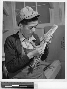 Man polishing greasewood, Minidoka Relocation Center, Hunt, Idaho, December 9, 1942