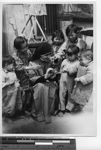 Maryknoll Sister with a group of children at Meixien, China, 1940