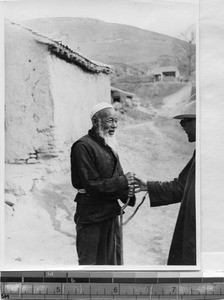 Moslem man greeting another, Gansu, China, 1936