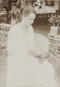 Emily Godfrey feeding baby, Nigeria, ca. 1922