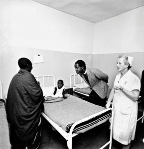 Tanzania, Kagera Region. Bishop Josiah Kibira on a 'ward round' at Izimbya Clinic, 1971. To the